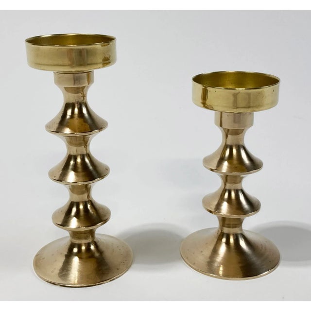 Vintage pair of solid brass mid century modern votive candle holders with unique ribbed stems. Fabulous patina.