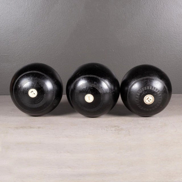 ABOUT A set of English lawn bowls made of Lignum Vitae Wood inlaid with bone. Monogrammed "AJG" and "WPS" and "1" and "2"...