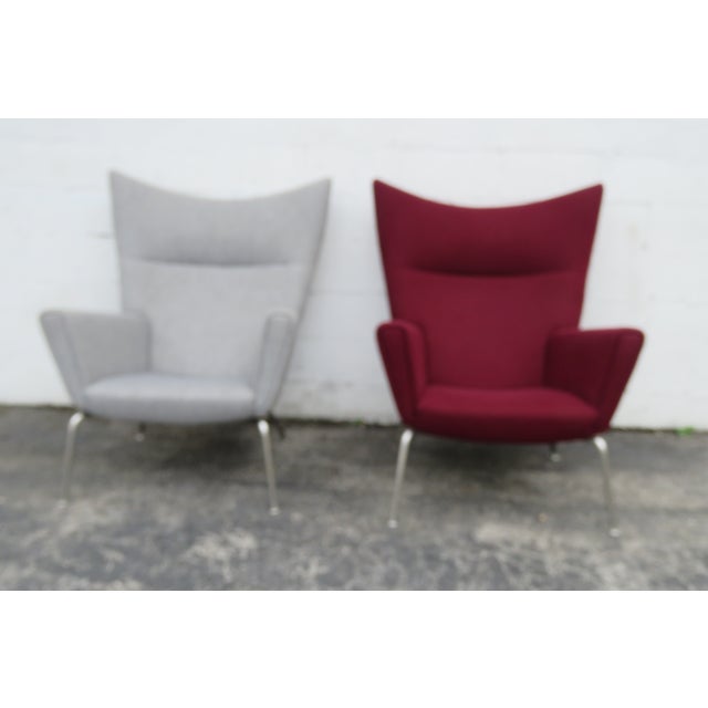 This Pair of Wing Side Chairs are made of metal, and fabric. We believe the Chairs were made by Hans Wegner for Carl...