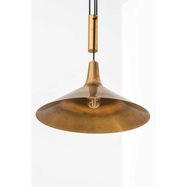 This rare height-adjustable ceiling lamp, designed by thomas valentiner and produced by poul dinesen in denmark,...