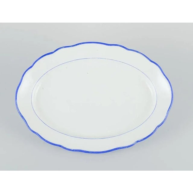 Meissen, Germany. Oval serving dish. White porcelain with blue rim. Early 20th century. Marked. Third factory quality. In...