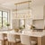 Architectural lines and a warm champagne bronze finish give this Kichler Delvin chandelier an elegant presence. Its...