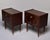 This pair of Mid-Century nightstands features drop-front doors with brass geometric inlay forming stepped corner motifs....