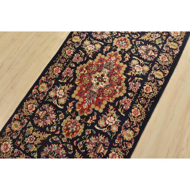An authentic vintage traditional Qom rug hand-knotted with fine wool and natural dyes. This intricately woven rug features...