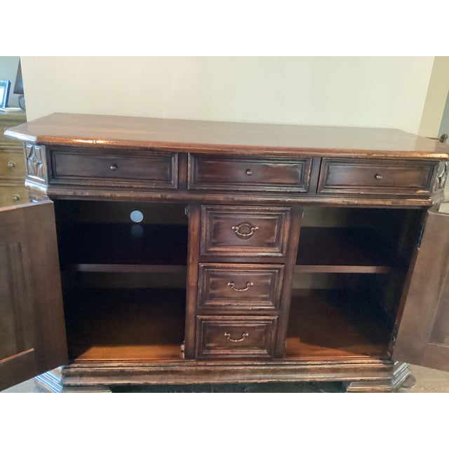 This is an heirloom quality traditional dark wood sideboard with rich brown finish by high end SOUTH CONE Designs. This...