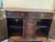 This is an heirloom quality traditional dark wood sideboard with rich brown finish. This piece has three top drawers, two...