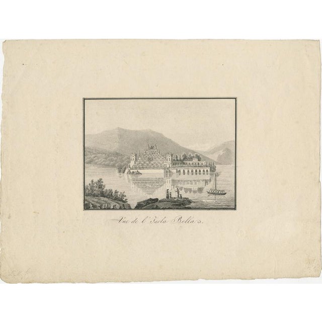 This early 19th-century lithograph offers a calm and finely detailed view of Isola Bella on Lake Maggiore, capturing the...