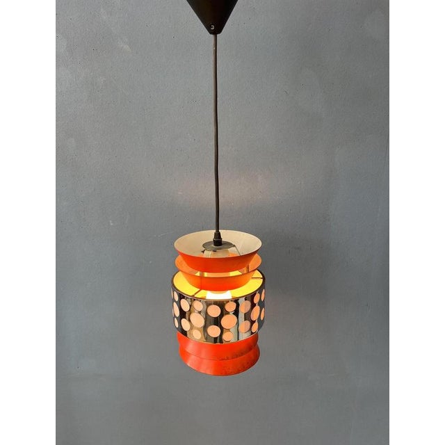 Orange and chrome vintage pendant lamp by Massive Belgium. The lamp is made out of layered metal. The lamp requires one...
