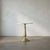 Two elemental materials meet in this quietly dramatic accent table. The base is formed of cast iron with a soft gold...