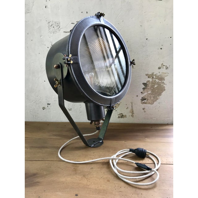 This industrial projector made of cast aluminum. It was likely used by the Navy and was produced by Holophane (signed on...