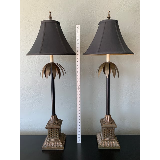 Pair of Large Palm Buffet lamps with Brass Accents. Brass has a patina to it. Black shades with Gold lining and matching...