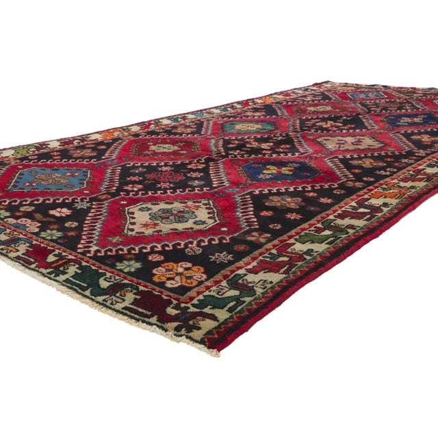 61038 Vintage Persian Shiraz Rug, 05'02 x 09'11. A ruggedly enchanting tale unfolds in the embrace of this hand-knotted...