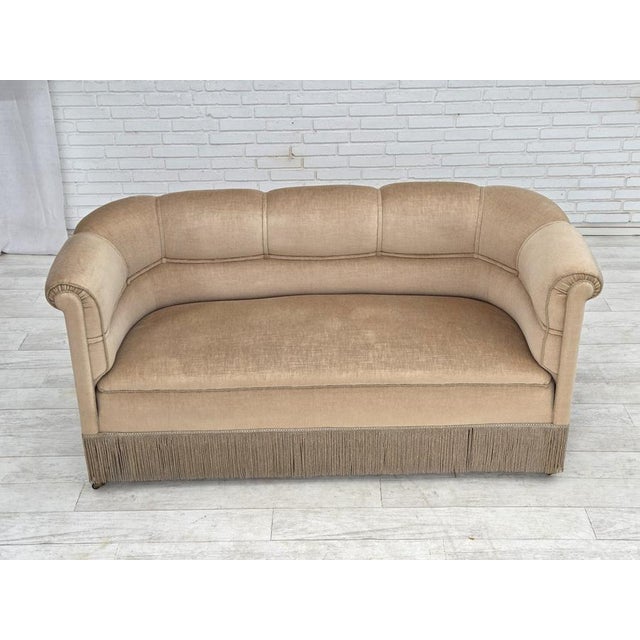 1950s, Danish 2-seater sofa. Beige furniture velour, teak wood legs with brass plugs (with wheels on the front legs),...