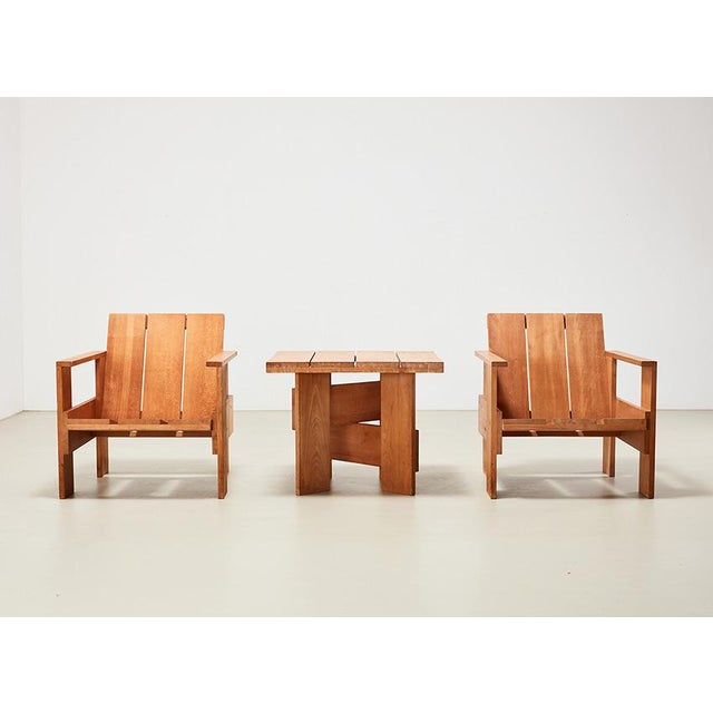 Pair of Crate chairs + matching table, designed by the great architect and designer Gerrit Rietveld in 1934. This set is...
