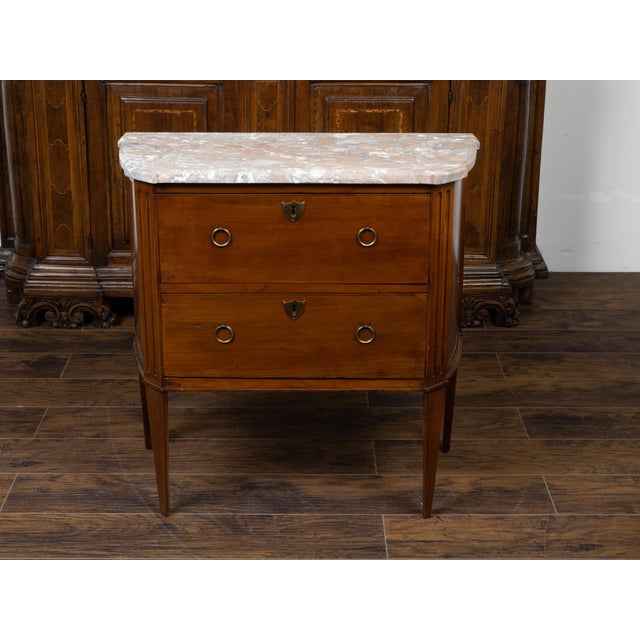 A French walnut commode from the 19th century, with variegated marble top and two drawers. Created in France during the...