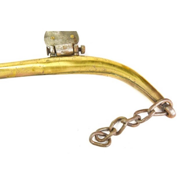 A pair of 19th century curved solid brass horse hames—for mounting to a draft horse's collar for pulling a harness...