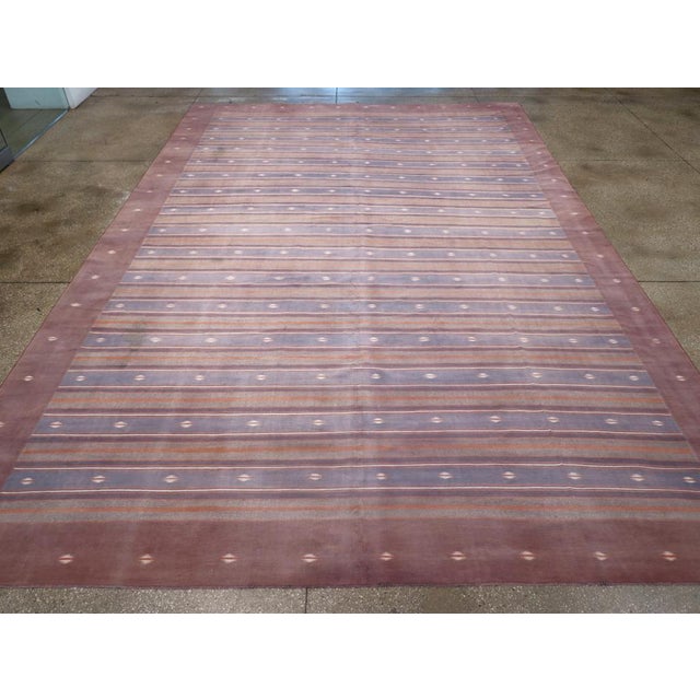 A Indian flatweave dhurrie room size carpet handmade during the Mid-20th Century Measures: 10' 8" x 15' 11"