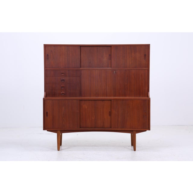 Vintage teak highboard with a practical interior layout and striking design. Ample storage space with a clean, modern...