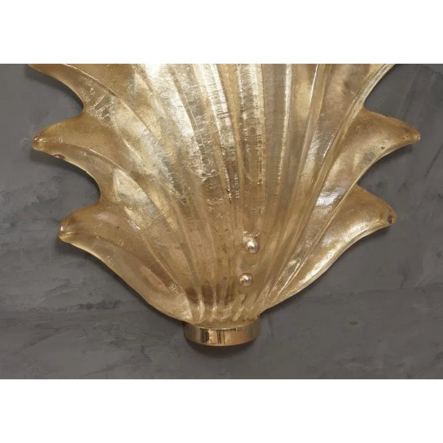 Majestic leaf in Murano glass of a wonderful gold color, made even more beautiful by the polished brass base. The applique...