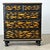 A 19th-century English pine chest recently updated with new paint of ebonized effect and pasted decoupage fish. The...