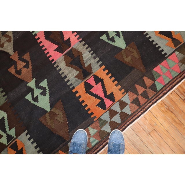 Tribal hand knotted mid-20th century Turkish Kilim / The background is brown and charcoal, accents in gray, light green,...