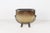 Mid-century sculptural jardinière featuring an oval glass vessel with a graduated smoked gold finish, suspended within a...