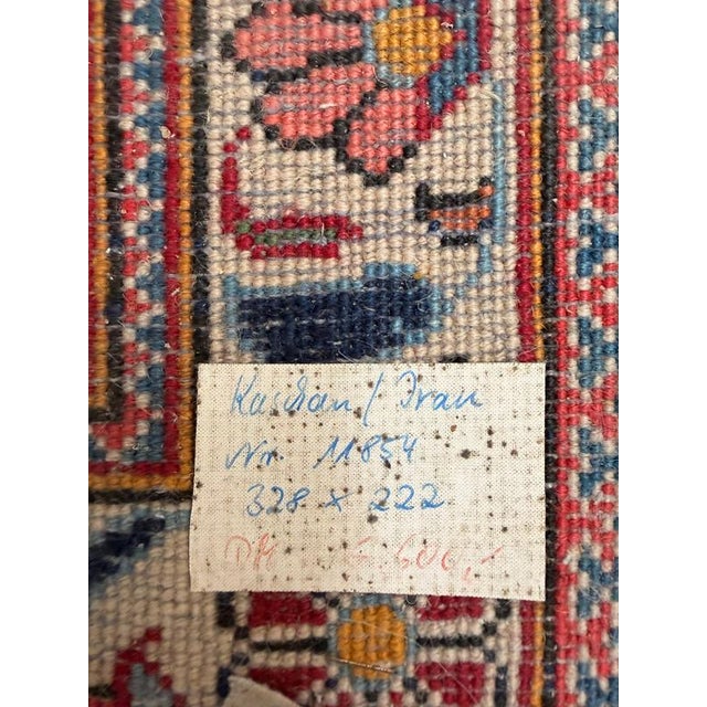 A beautiful large-format hand-knotted Persian Kashan rug, showcasing the exceptional craftsmanship and rich decorative...