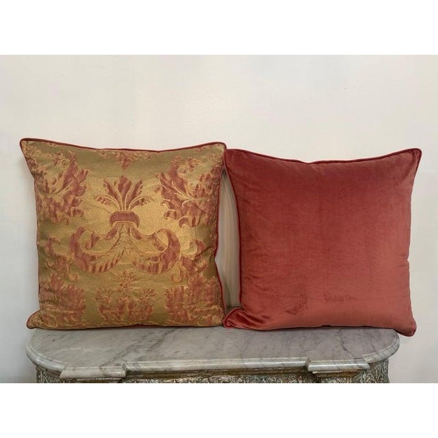 A sumptuous and highly decorative pair of custom pillows in the grand Venetian tradition, rendered in a luminous antique...