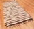 Abbreviated stripes and birdlike accents rendered in a stark combination of walnut brown, ivory and splashy colors...