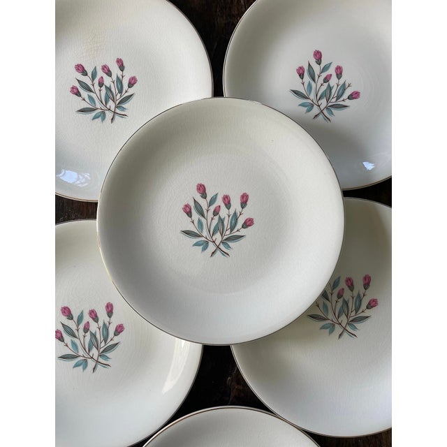 Lovely set of six plates by Wedgewood, presented in a very soft creamy white with a floral bouquet in the center of rosy...