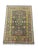 A charcoal gray field carries a balanced geometric design in soft blue, gold, burgundy, and cream. Two bold medallions,...