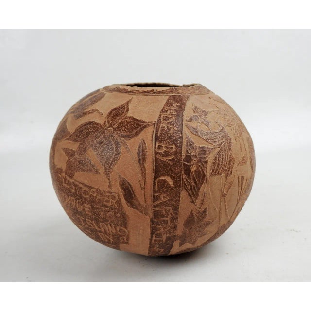 Vintage mid 20th century handcarved folk art gourd. From the Caribbean signed by Captai Foster Love, with notation...