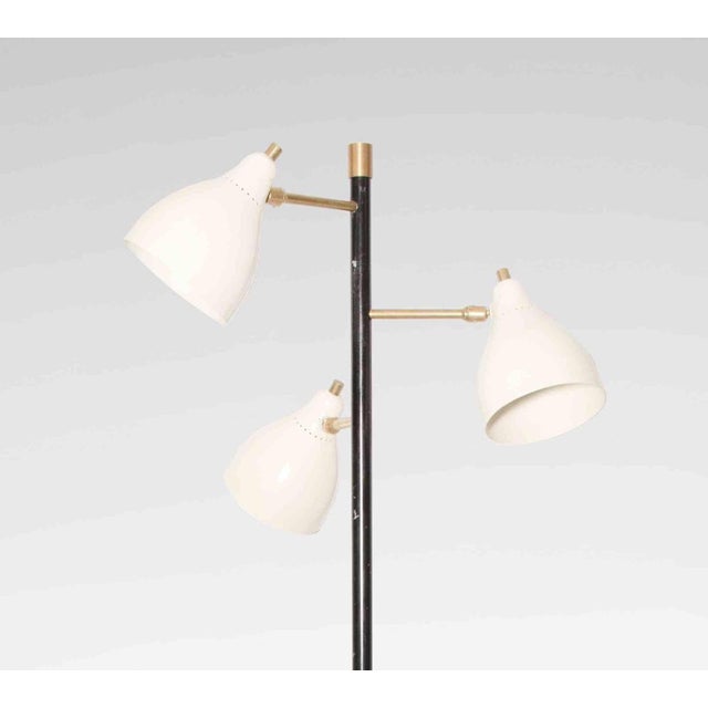 Vintage floor lamp is an original design lamp realized in the Mid 20th century. A beautifil three lights metal and brass...