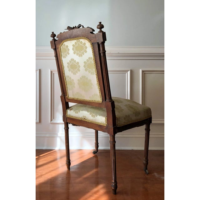 A 19th C. Walnut Louis XVI Style Chaise a La Reine. With musical and ribbon cravings and original silk Upholstry. Some...