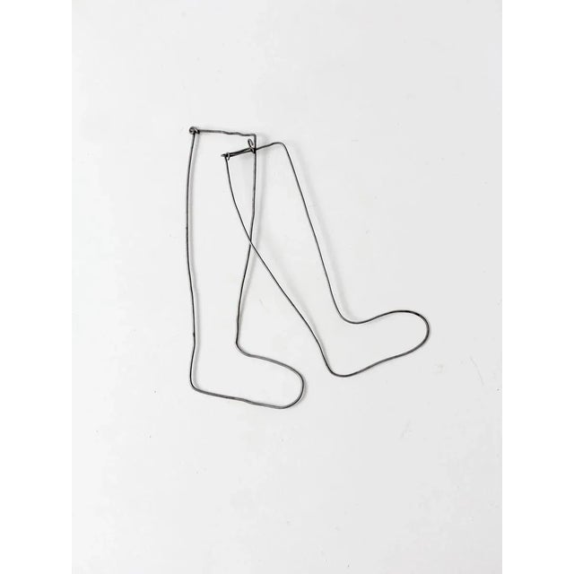 Pair of antique children's sock stretchers in slender metal. Originally used to display socks and stockings in stores,...