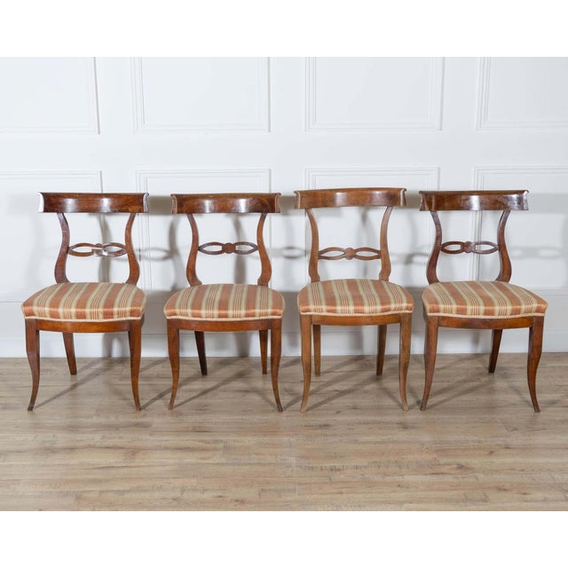 A refined set of four Tuscan chairs dating from the late 18th to early 19th century, beautifully crafted in solid walnut....