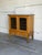 This oak display cabinet in style of Henning Kjærnulf combines two glass-front doors with two lower drawers. Sculpted...