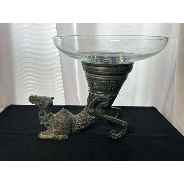This very large piece combines a bronze pedestal in the shape of a camel cornucopia with a heavy crystal bowl. The...