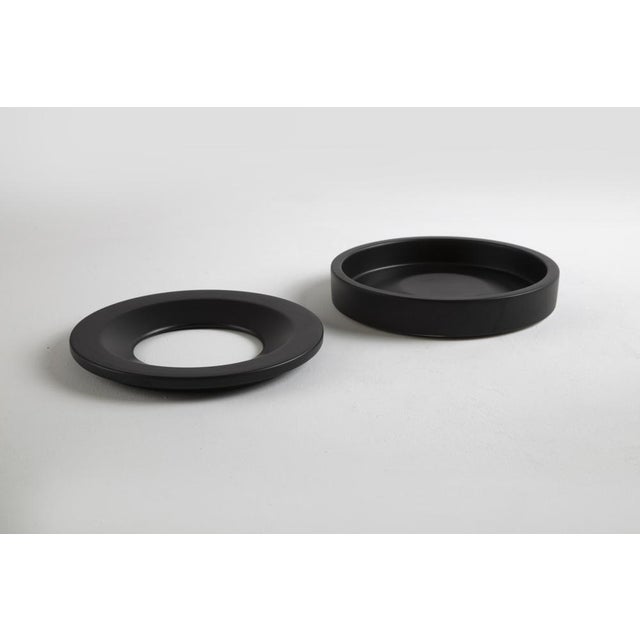 Ashtray mod. Barbados in glazed ceramic, composed of a base and a partial covering upper ring. Signed and marked on the...