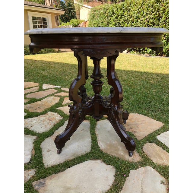 Beautifully refinished side table with mahogany stain. Solid Carrara marble top was also refinished and polished with a...
