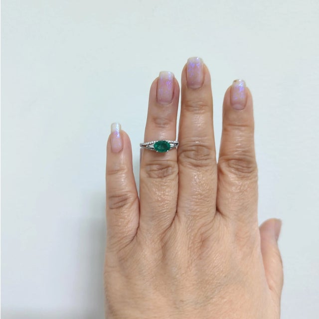 Beautiful 1.07 ct. emerald oval with good quality white diamond rounds and baguettes. Emerald is set east to west, giving...