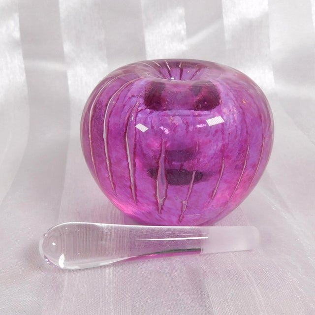 This is a small pink bullicante art glass perfume bottle. It is not signed. Someone has added a piece of something to the...