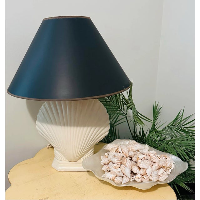 Fabulous vintage pair of vintage Miami Beach lamps, Clam shell formed an original cream color finish with black shade. It...