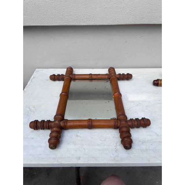 Small French faux bamboo wood mirror, circa 1900. Height 16 inches, depth 14 inches.