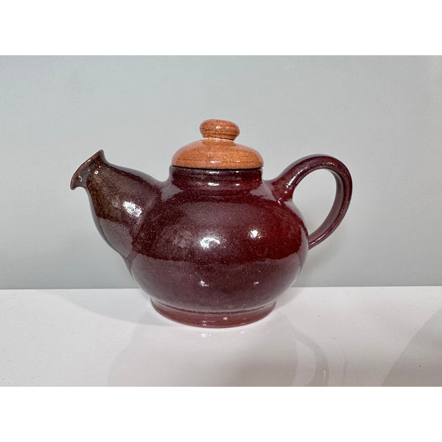 This handcrafted set from the workshop of Helma Klett (1908-1996) consists of a bulbous teapot and two matching cups, each...