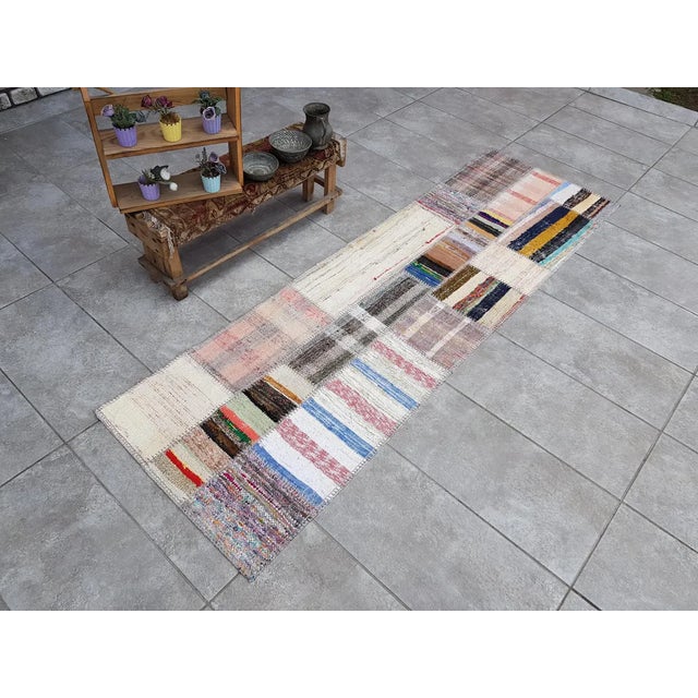 This is a vintage Turkish Oushak rug from the Mid 20th Century. The piece was hand-knotted.