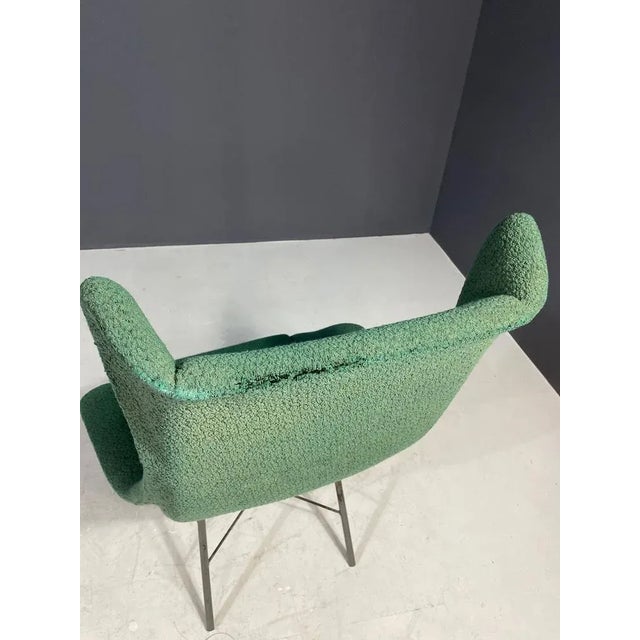 An iconic shell chair from the 1960s. The ergonomically shaped fiberglass shell rests on a slender metal base, newly...