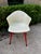 Gorgeous red legs and a swivel seat on this great Eames style chair. An off white or cream color molded fiberglass seat...