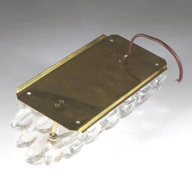 Wall lights by Carl Fagerlund for Orrefor made in Sweden around 1960 Thick bubbles glass mounted on brass with brass...
