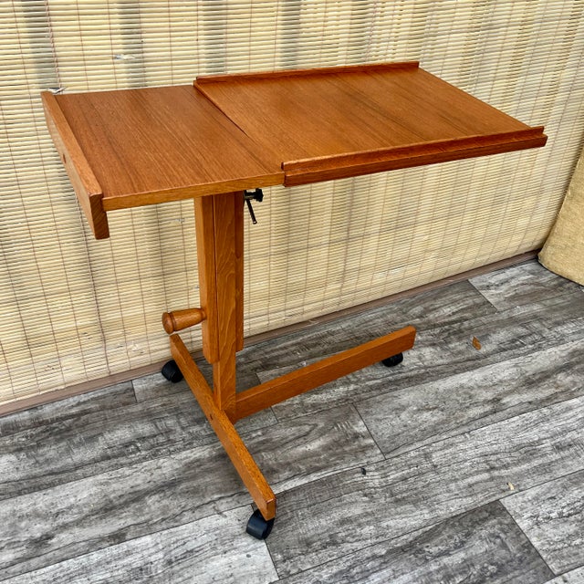 Vintage Mid-Century Modern Danish Adjustable Rolling Tray Table / Cart. Circa 1970s. Features a minimalist Scandinavian...